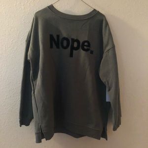 “Nope.” olive green sweatshirt